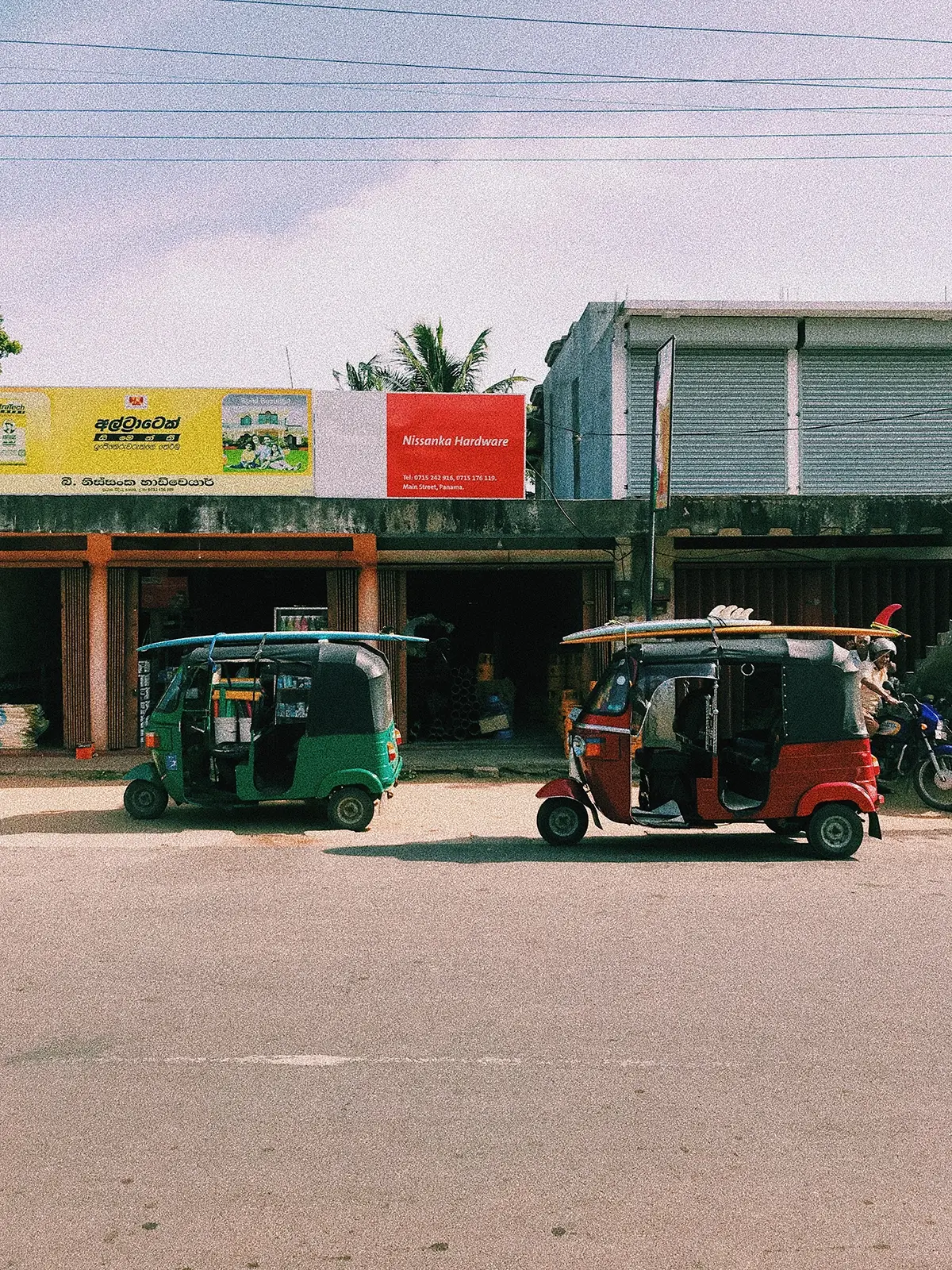 Tuktuk with surfboards on the roof in ceylon